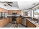 Bright kitchen features stainless steel appliances, tile floors, and granite counters at 930 N Sandal Cir, Mesa, AZ 85205