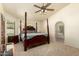 A spacious primary bedroom features a four-poster bed and ensuite bathroom at 930 N Sandal Cir, Mesa, AZ 85205