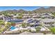 Home with solar panels features a pool, spa, patio, and putting green, nestled in the desert landscape at 9347 E Hillview Cir, Mesa, AZ 85207