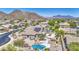 Residential house with solar panels, pool, spa, and putting green, set against the backdrop of scenic mountain views at 9347 E Hillview Cir, Mesa, AZ 85207