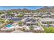 Home with solar panels featuring a pool, spa, patio, and putting green, perfect for outdoor entertaining at 9347 E Hillview Cir, Mesa, AZ 85207