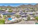 Bird's eye view of a desert home with a pool, green landscaping, and beautiful mountain views at 9347 E Hillview Cir, Mesa, AZ 85207