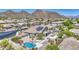 Home with solar panels, pool, spa, and putting green, nestled in a serene desert community with mountain views at 9347 E Hillview Cir, Mesa, AZ 85207