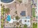 Aerial view of a backyard showcasing a beautiful pool, hot tub, landscaping, and rooftop solar panels at 9347 E Hillview Cir, Mesa, AZ 85207