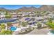 Home with solar panels features a pool, spa, patio, and putting green, nestled in the desert landscape at 9347 E Hillview Cir, Mesa, AZ 85207