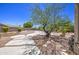 Backyard featuring decorative landscaping, gravel walkways, a lawn, and pool in background at 9347 E Hillview Cir, Mesa, AZ 85207