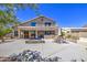 Expansive backyard with a covered patio, spa, dining table, and well-manicured landscaping at 9347 E Hillview Cir, Mesa, AZ 85207