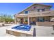 View of a spacious backyard patio with a spa and overhead covering for comfortable outdoor living at 9347 E Hillview Cir, Mesa, AZ 85207