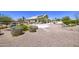 Huge, open backyard with gravel cover and desert landscaping with pool in background at 9347 E Hillview Cir, Mesa, AZ 85207