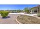 Backyard featuring decorative landscaping, a lush lawn, a pool, and gravel walkways at 9347 E Hillview Cir, Mesa, AZ 85207