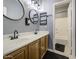 Bathroom featuring dual sinks, elegant mirrors, and contemporary lighting for a stylish retreat at 9347 E Hillview Cir, Mesa, AZ 85207