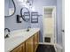 Bathroom featuring dual sinks, elegant mirrors, and contemporary lighting for a stylish retreat at 9347 E Hillview Cir, Mesa, AZ 85207