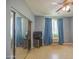Spare bedroom with mirrored closet doors, light floors, and a window provides natural light at 9347 E Hillview Cir, Mesa, AZ 85207