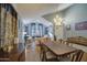 Elegant dining room featuring hardwood floors, chandelier lighting, and neutral wall colors at 9347 E Hillview Cir, Mesa, AZ 85207