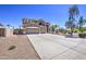 Spacious home with a three-car garage, desert landscaping, and a long driveway at 9347 E Hillview Cir, Mesa, AZ 85207