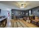 Large game room with a bar, hardwood floors, and dark grey walls, perfect for entertaining guests at 9347 E Hillview Cir, Mesa, AZ 85207