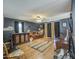 Spacious game room with a bar, ceiling fan, hardwood floors, and dark grey walls at 9347 E Hillview Cir, Mesa, AZ 85207