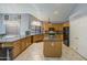 Bright kitchen features granite counters, a center island, oak cabinets, and black appliances at 9347 E Hillview Cir, Mesa, AZ 85207