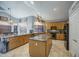 Bright kitchen features granite counters, a center island, oak cabinets, and black appliances at 9347 E Hillview Cir, Mesa, AZ 85207
