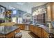 Open kitchen with granite counters, oak cabinets, stainless steel appliances and a pot rack at 9347 E Hillview Cir, Mesa, AZ 85207