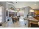 Kitchen and dining area with granite counters, oak cabinets, tile floors and modern lighting at 9347 E Hillview Cir, Mesa, AZ 85207