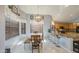 Kitchen and dining area with granite counters, oak cabinets, tile floors and modern lighting at 9347 E Hillview Cir, Mesa, AZ 85207