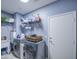 Functional laundry room with modern washer, dryer, sink, and storage space at 9347 E Hillview Cir, Mesa, AZ 85207