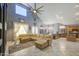 An open-concept living room with natural light, tile flooring, and vaulted ceilings at 9347 E Hillview Cir, Mesa, AZ 85207