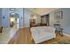 Bright living room with wood floors and a white tufted sofa, perfect for relaxing and entertaining guests at 9347 E Hillview Cir, Mesa, AZ 85207