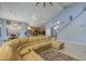 Spacious living room featuring vaulted ceilings and an open floor plan adjoining the kitchen and dining area at 9347 E Hillview Cir, Mesa, AZ 85207