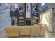 The vaulted living room is well-lit and has a large sectional sofa and a decorative entertainment center at 9347 E Hillview Cir, Mesa, AZ 85207