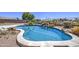 Tranquil pool surrounded by desert landscaping, creating a serene and private outdoor oasis at 9347 E Hillview Cir, Mesa, AZ 85207