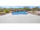 Inviting pool area with a waterfall feature and ample deck space, perfect for outdoor enjoyment at 9347 E Hillview Cir, Mesa, AZ 85207