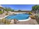 Beautiful pool with rock features and lush landscaping, perfect for relaxation and recreation at 9347 E Hillview Cir, Mesa, AZ 85207