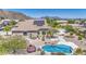 Gorgeous single story home with large roof-mounted solar panels, pool, and desert landscaping at 9347 E Hillview Cir, Mesa, AZ 85207