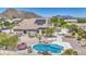 Aerial view of the property displaying the pool, desert landscaping, and unique backyard features at 9347 E Hillview Cir, Mesa, AZ 85207