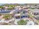 Aerial view of the home's backyard including a covered patio, balcony, pool, spa, and desert landscaping at 9347 E Hillview Cir, Mesa, AZ 85207