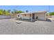 View of the backyard with gravel, a covered patio, and block fencing at 1017 S Allen --, Mesa, AZ 85204