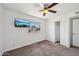 Inviting bedroom with a mounted TV, large window, and a closet for ample storage at 1017 S Allen --, Mesa, AZ 85204