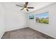Bedroom with a mounted TV, neutral carpet, and window views, offering a cozy retreat at 1017 S Allen --, Mesa, AZ 85204