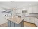 Bright, remodeled kitchen featuring white cabinetry, granite countertops, and modern pendant lighting above the kitchen island at 1017 S Allen --, Mesa, AZ 85204