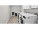 Bright laundry room featuring front load washer, dryer, and cabinet storage for convenience at 1017 S Allen --, Mesa, AZ 85204