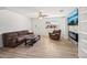 Spacious living room featuring wood-look tile floors, a ceiling fan, and a large window offering abundant natural light at 1017 S Allen --, Mesa, AZ 85204