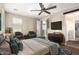 Comfortable bedroom with a ceiling fan and ample natural light at 10221 E Wavelength Ave, Mesa, AZ 85212