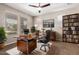 Home office showcasing a large desk, built-in bookcase, and ample natural light at 10221 E Wavelength Ave, Mesa, AZ 85212