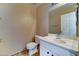 Bathroom featuring a white vanity, toilet, and a large mirror at 10524 W Pima St, Tolleson, AZ 85353