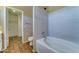 Updated bathroom boasts modern bathtub, shower, and tiled walls at 10524 W Pima St, Tolleson, AZ 85353