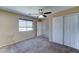 Bedroom boasts closet, ceiling fan, neutral carpet, and natural light at 10524 W Pima St, Tolleson, AZ 85353