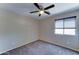 Bedroom with neutral carpet, ceiling fan, and natural light at 10524 W Pima St, Tolleson, AZ 85353