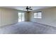 Bedroom featuring neutral walls, carpet flooring, a window, ceiling fan and patio access at 10524 W Pima St, Tolleson, AZ 85353